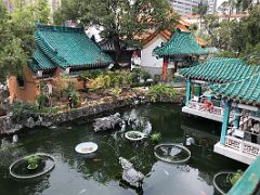 09C A small pond with various pavilions in the Good Wish Garden at Wong Tai Sin temple Hong Kong